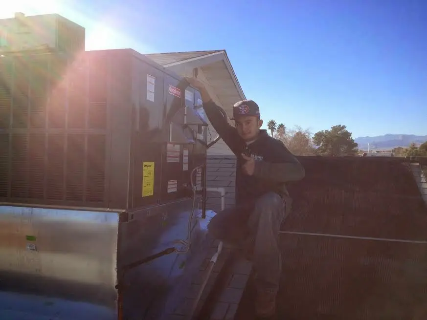 HVAC technician performing HVAC Inspection on a rooftop unit in Lake Wisconsin